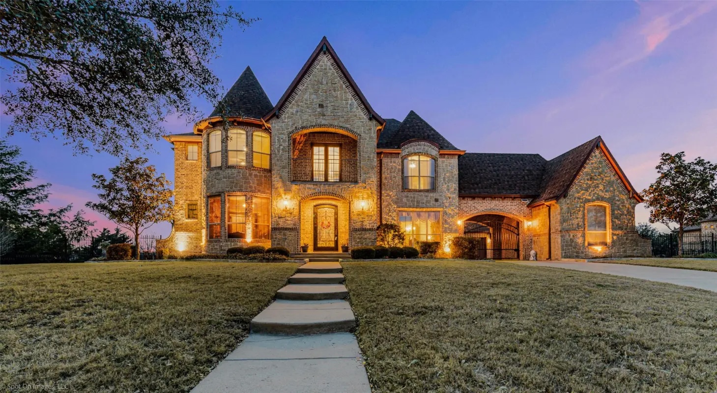 Luxury brick and stone estate at dusk in Heath, TX