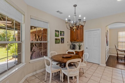 Tile breakfast nook with round table and backyard-view windows