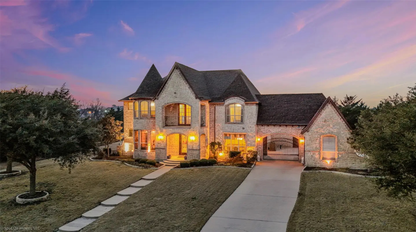 Custom brick estate at dusk in Rockwall County, TX