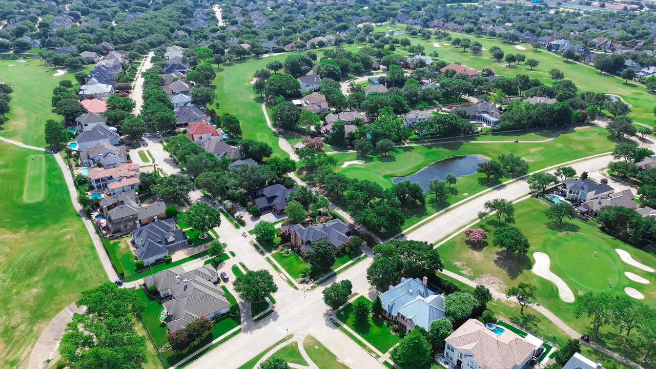 Aerial view of luxury homes by the water in a master-planned Texas community — Prosper, TX