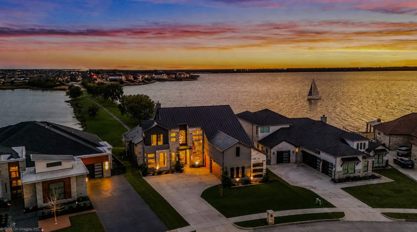 Luxury brick and stone estate at dusk in Heath, TX